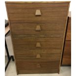 A vintage dark wood 5 drawer chest with wooden handles.