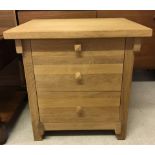 A solid wood modern light oak 3 drawer bedside cabinet.