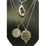 3 large decorative pendants on silver chains.