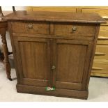 A small oak 2 drawer 2 door hall cupboard.