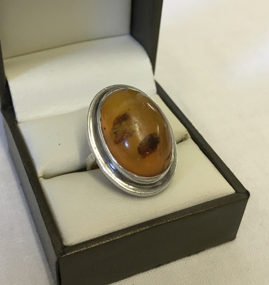 Large oval amber ring set in silver.