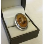 Large oval amber ring set in silver.