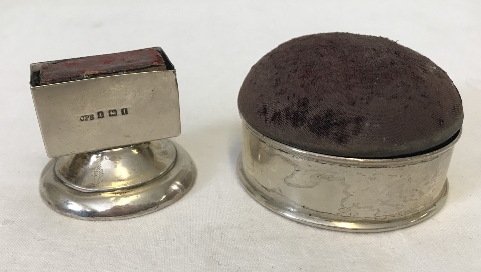 A silver cased pin cushion/box together with a silver matchbox holder.