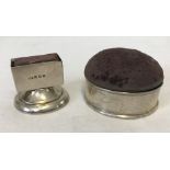 A silver cased pin cushion/box together with a silver matchbox holder.