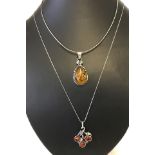 An Art nouveau style amber set pendant together with a modern design amber set pendant marked 925.