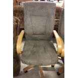 A faux beige suede and light wood office chair on castors.