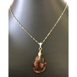 A amber drop pendant on a box link style 18 inch 9ct gold chain.