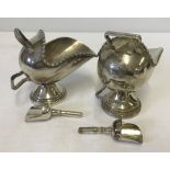 2 matching silver plated scuttle shaped salts with shovel shaped spoons. One marked Mappin & Webb.