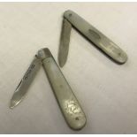 2 silver and mother of pearl handled fruit knives 1 with empty cartouche.