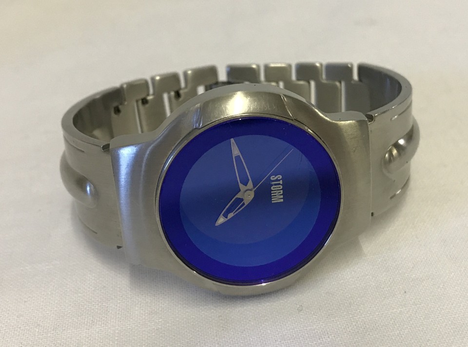 A men's Storm blue dial silver tone stainless steel bracelet wrist watch.