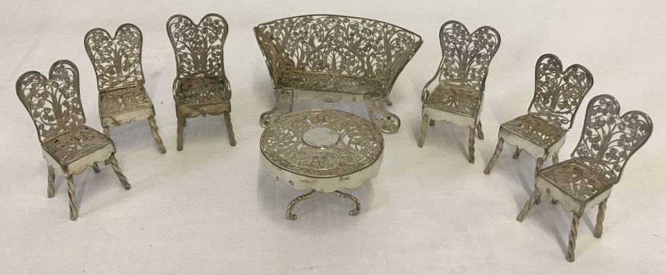 A continental silver miniature filigree table & chair set.