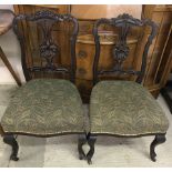 A pair of Victorian mahogany nursing / bedroom chairs with ornate carving to chair backs.