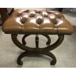 A vintage x frame leather button topped stool.