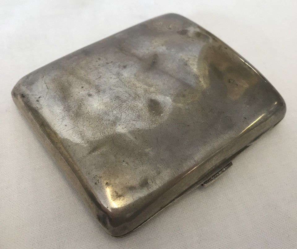 A hallmarked silver cigarette case with P.G.E. monogram to top left corner.