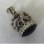 A small silver fob with lion detail to top, set with black onyx cabochon.