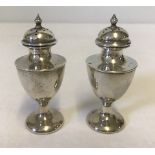 A silver cruet matching salt and pepper pot, hallmarked Birmingham 1908.