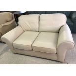 A 2 seater Marks & Spencer Cream leather sofa.