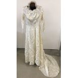 A 1955 handmade wedding dress with head dress and underslip.