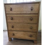 A 4 drawer light oak vintage solid wood small chest of drawers.