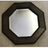 A small vintage octagonal dark oak framed wall hanging mirror.