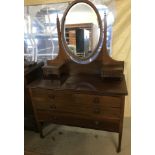 An Edwardian 4 drawer dressing table with oval mirror back and inlaid detail.