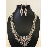 Striking white metal and enamelled necklace with matching earrings.