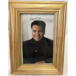 A Muhammad Ali signed small colour portrait photograph.