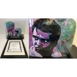 A cased pair of Muhammad Ali signed boxing gloves, also painted with portrait of Ali by Bill Lopa.