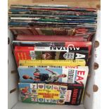 A box of vintage football books and magazines.