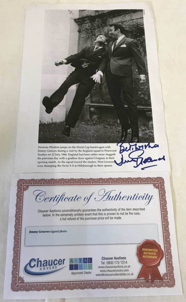 A signed photograph of footballer Jimmy Greaves with comedian Norman Wisdom.