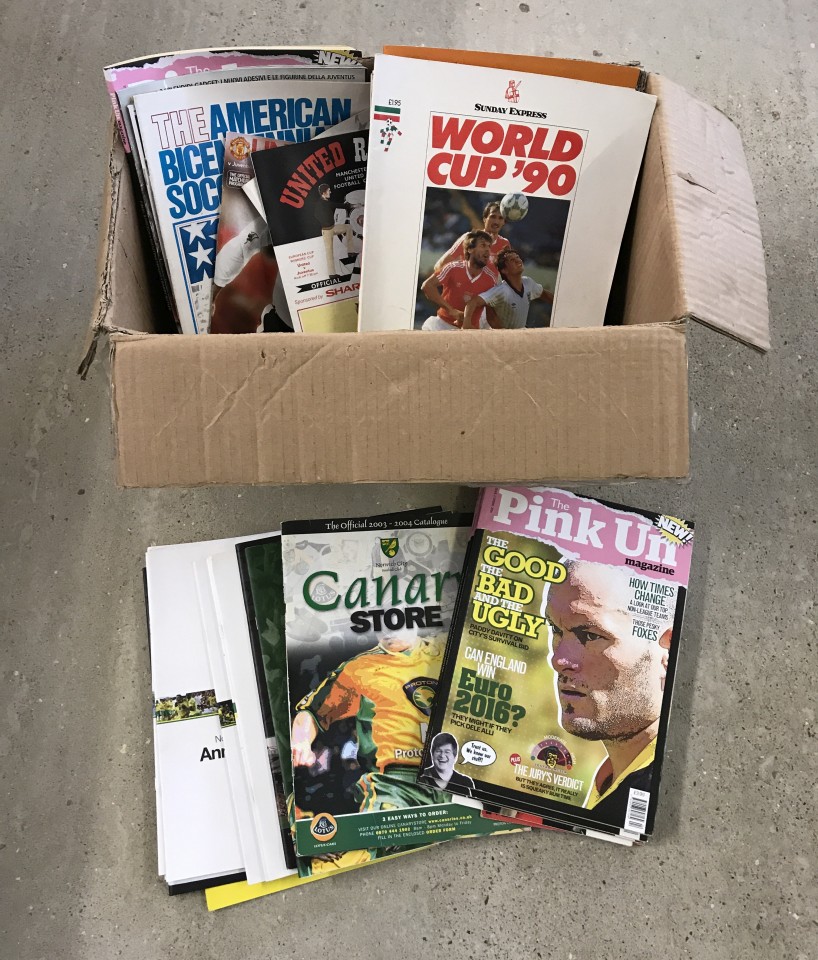 A box of assorted magazines, programmes and catalogues relating to football.