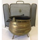 A vintage brass 3 legged cauldron style coal bucket together with a folding fire screen.