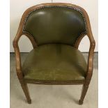 A vintage light wood curve backed captains chair with olive green studded leather upholstery