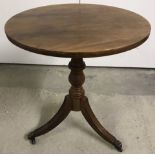 A small round topped occasional table on pedestal base with tripod legs.