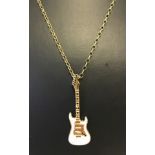 A silver gilt guitar shaped pendent on a silver gilt link chain.