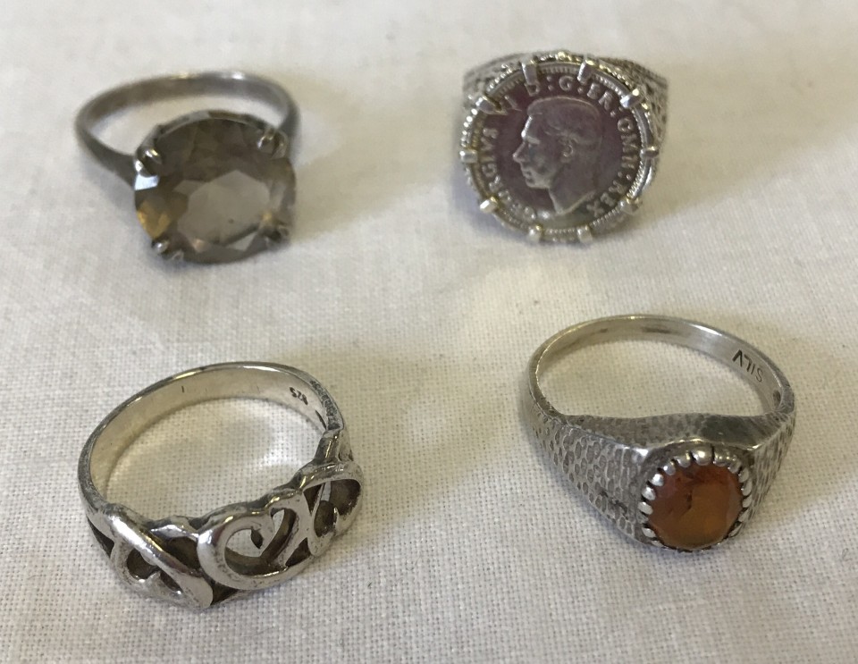 4 silver dress rings.