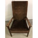 A vintage wooden framed easy chair with brown velvet upholstery.
