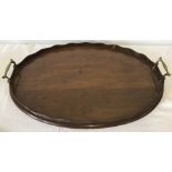 An Edwardian oval mahogany tea tray with pie crust edge.