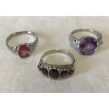 3 silver stone set rings. To include garnet.