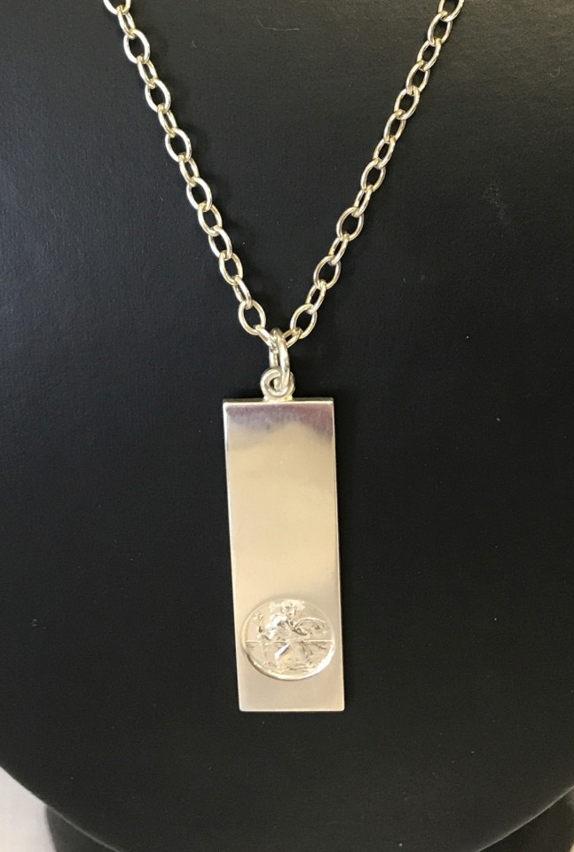 A unusual shaped silver St. Christopher pendant on a 20 inch silver chain.