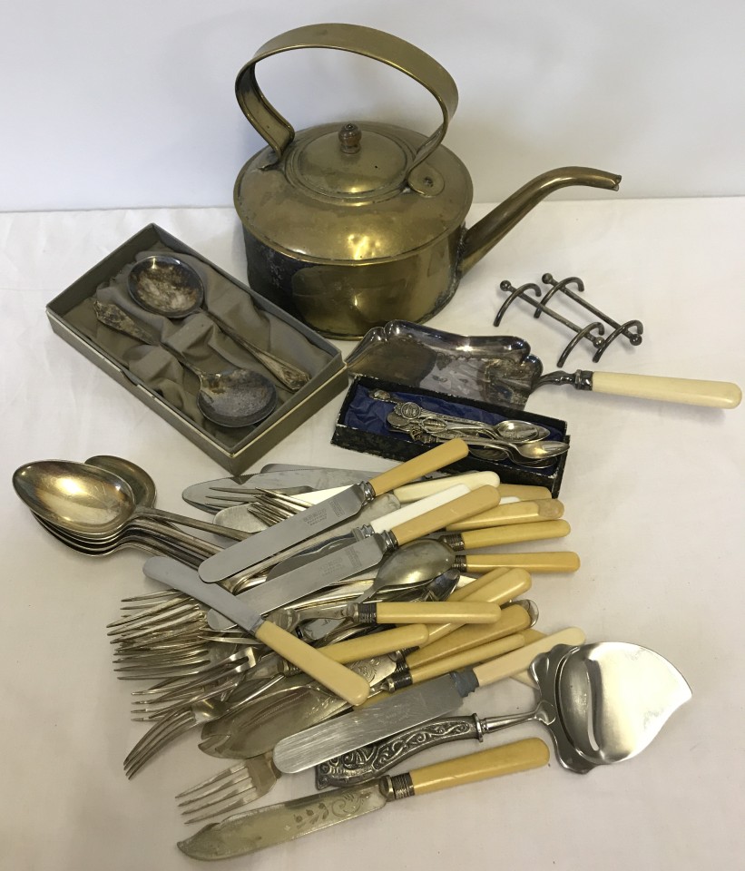 A quantity of assorted metalware and cutlery to include kettle, crumb tray and silver spoons.