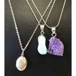 3 silver necklaces. One small oval locket together with two natural stone.