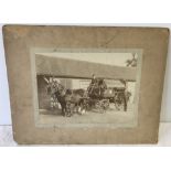 A large mounted black and white photograph depicting horse and cart.