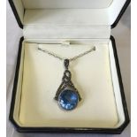 A large 925 silver drop pendant set with a blue stone and marcasites on a 18 inch silver chain.