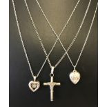 3 silver necklaces. 2 with heart shaped pendants the other a cross.