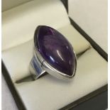 A 925 modern silver ring set with marquise cut amethyst.