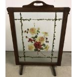 A vintage wooden framed firescreen with hand painted glass panel.