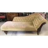 A vintage wooden framed chaise longue with button back velvet upholstery and turned legs.