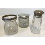 A silver lidded jar together with a silver topped sugar sifter and silver rimmed preserve pot.