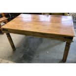 A large solid Indian rubberwood dining table with metal banding detail.